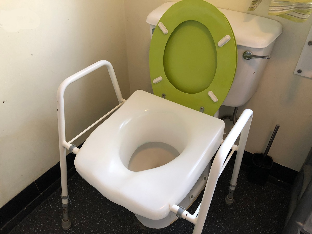 Raised toilet seat with frame