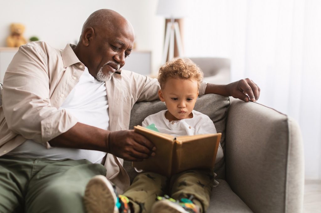 Senior reading to child