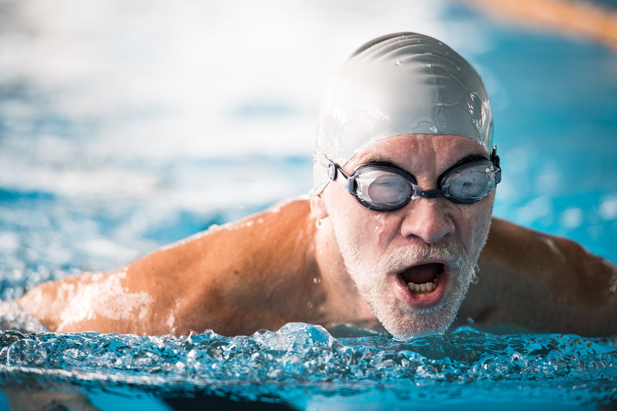 Senior man swimming laps