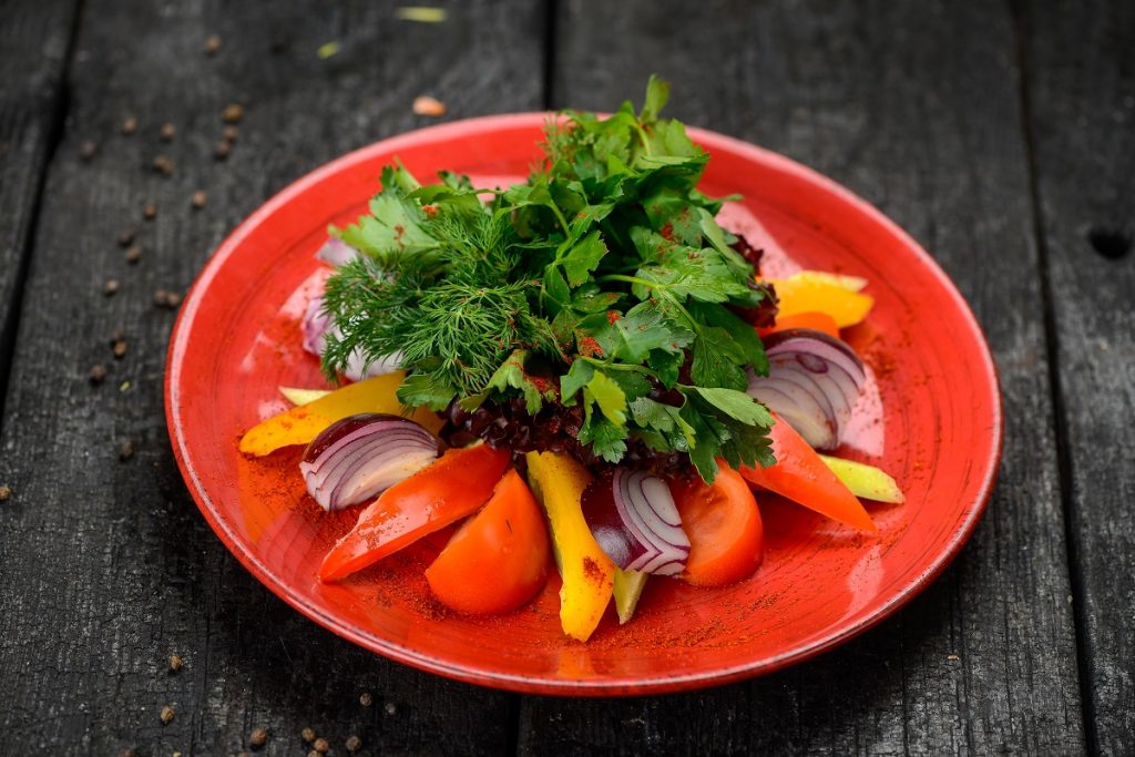 Salad on red plate