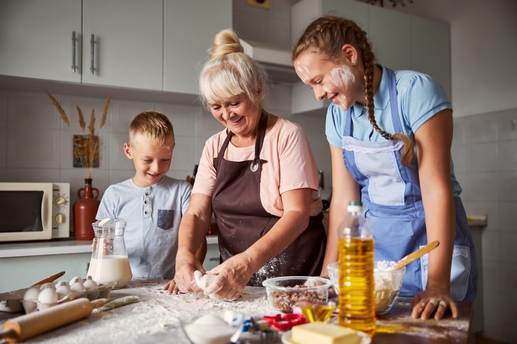 Grandma teaching young how to cook