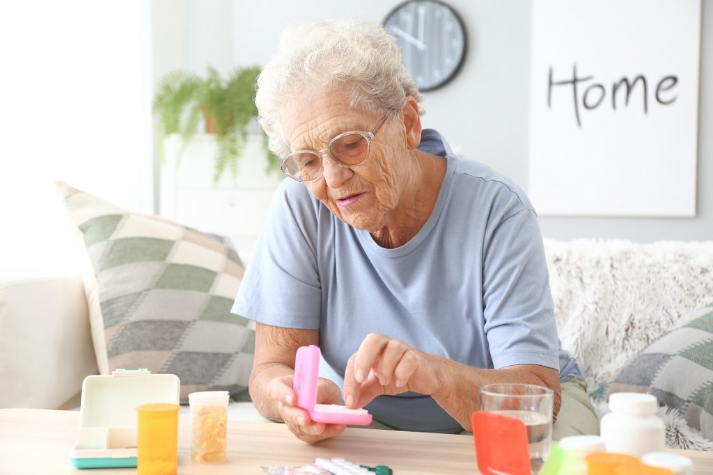 Woman filling pill box